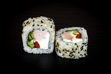 Sushi and rolls on a black