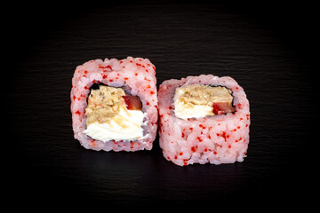 Sushi and rolls on a black