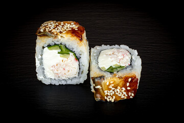 Sushi and rolls on a black