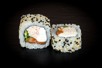 Sushi and rolls on a black