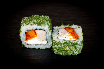 Sushi and rolls on a black