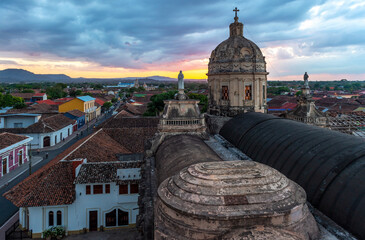 La Merced church Dome at sunset with Virgin Mary sculptures and the city skyline, Granada,...