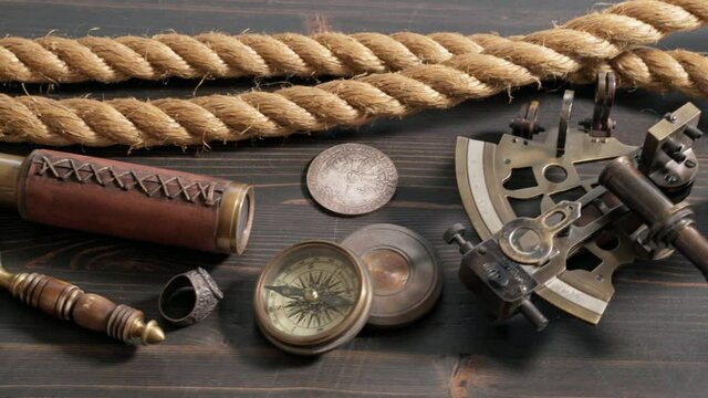Tracking shot of various marine adventure items on old table