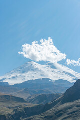 Scenic view of the highest peak in Europe, mount Elbrus with green hills on a Sunny summer day.