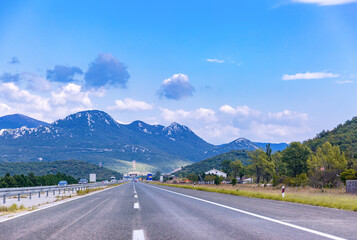 Naklejka premium Highway leading to mountains. Beautiful mountain landscape. Bitoraj mountains, Gorski Kotar, Croatia