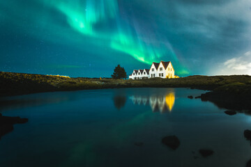 Fototapeta na wymiar Lonely houses under northern lights, Keflavik, Iceland