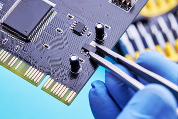 computer hardware support service concept. technician diagnosing and repairing pcb circuit board