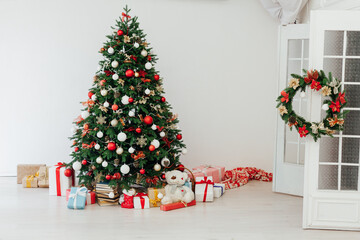Christmas tree pine with gifts of garland lights for the new year in the interior of the room as a white background