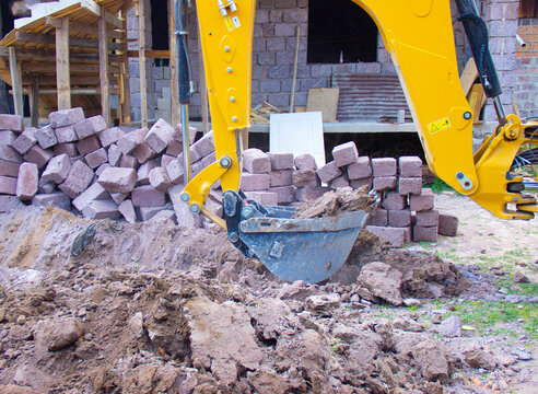 yellow exkavator on construction site  and stones.