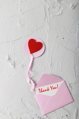 Romantic  Thank you or love card with red heart on cement background