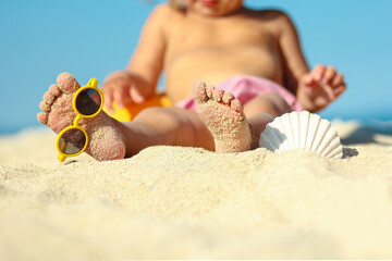 foots of Little child play on the beach seashore