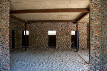 Obraz premium Construction of houses. Walls, brick internal partitions, ceiling made of blocks covered with clay, metal supports.