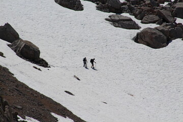 hikers crossing a snowfield