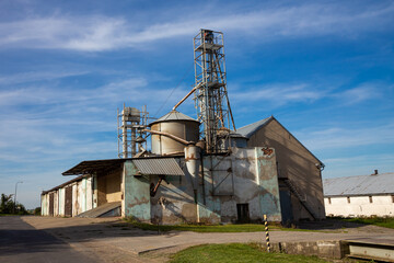Old farm in Poland with grain silo under the blue sky