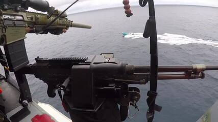 2020 Helicopter interdiction tactical squadron attached to the Coast Guard fires warning shots across the bow of a drug smuggler.