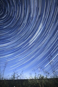 Concentric star tracks in the night sky. startrails. Vertical orientation.