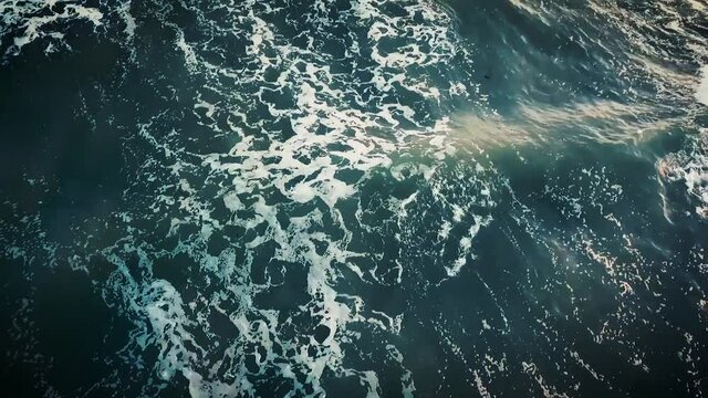 Aerial of waves coming into Normandy Beach, France for the 75th commemoration of D-Day, 2019