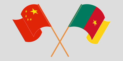 Crossed and waving flags of Cameroon and China