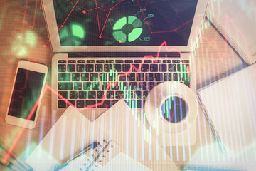 Stock market chart and top view computer on the table background. Double exposure. Concept of financial analysis.