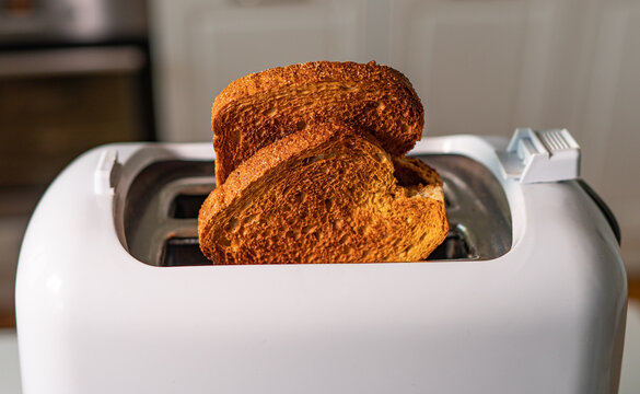 Two Roasted Toast Bread Popping Up Of Toaster.