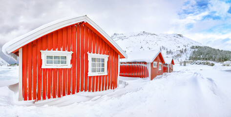 Wonderfull winter scenery with traditional Norwegian red wooden houses on the shore of Rolvsfjord on Vestvagoy island