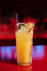 Exotic tropical cocktail with pineapple on the bar counter.