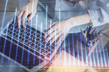 Double exposure of woman hands typing on computer and forex chart hologram drawing. Stock market invest concept.