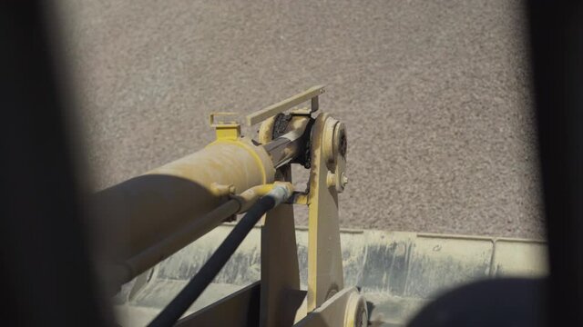 Driver's point of view, industrial machinery riding to pile of crushed stone fraction 10-20 and downloading bulk material for the production of concrete mixes.