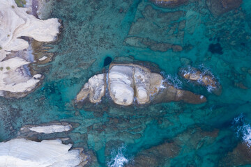 an aerial view of white rock formations on the seafront coastline of Limassol in Cyprus