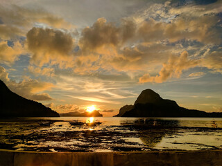 El Nido beach with sunset and amazing clouds formation in the background