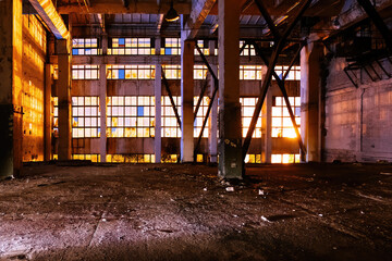 Dark creepy empty abandoned industrial building interior at night