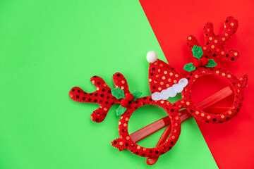 Christmas New year fancy glasses red reindeer antler on red and green background
