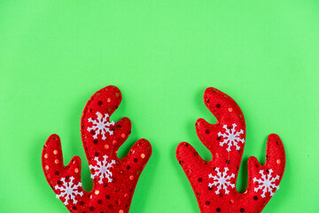 Christmas antlers of a deer on green background.