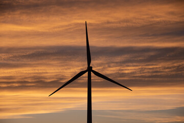 Sunset behind a field of wind turbines