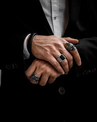 rings on hands and leather bracelet