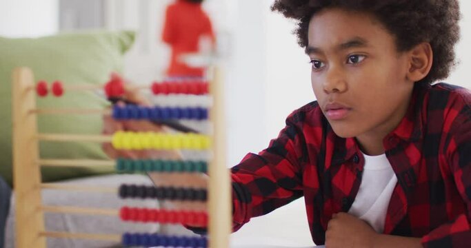Boy using abacus at home