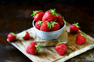 Fresh juicy strawberries in a bowl. Selective focus. Macro.