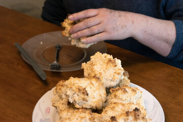 Elderly woman preparing baked and enjoying goods