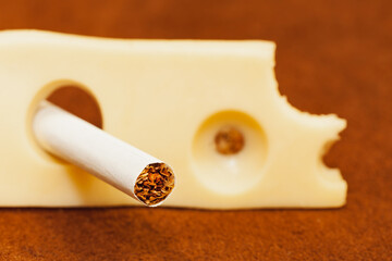 Close up cigarette in the hole of a piece of cheese, Quit Smoking, Stop Smoking Cigarette Concept.