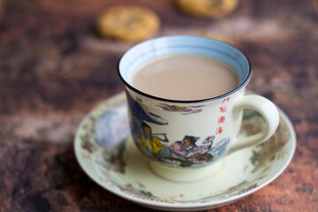 Hot milk coffee with abstract background and cookies