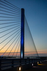 Fototapeta na wymiar steel bridge over waterway evening sky