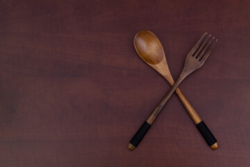 Wooden fork and spoon on wooden table with copy space