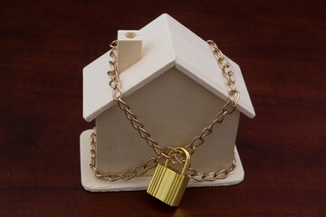 Locked house with padlock and chain close up