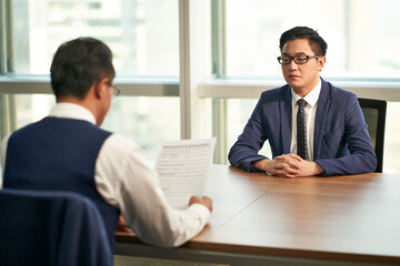 asian businessman being interviewed by hr manager in office