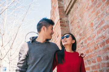 Fototapeta na wymiar Asian couple walking in the city.