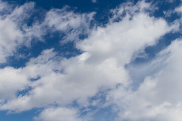 Naklejka na ściany i meble Bright blue sky and fluffy white clouds, wallpaper