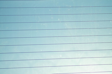 Thin dark lines on a background of blue sky.