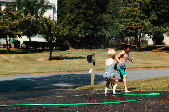 children playing with water hose