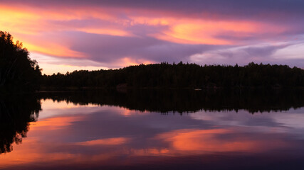 Fototapeta na wymiar Beautiful sunset reflecting in a lake in Quebec, Canada 