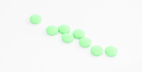 Pharmacology concept, green pills on white isolated background, horizontal banner